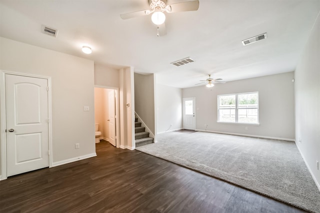 spare room featuring ceiling fan, stairway, and visible vents