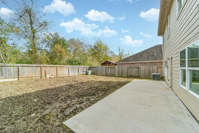 view of yard with a patio area, a fenced backyard, and central air condition unit