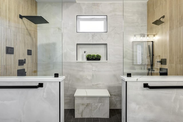 bathroom featuring tile patterned flooring, tile walls, and a walk in shower