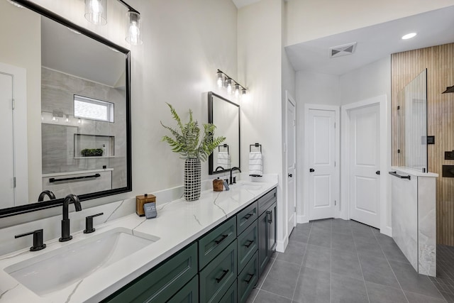 full bath with double vanity, tile patterned flooring, a sink, and visible vents