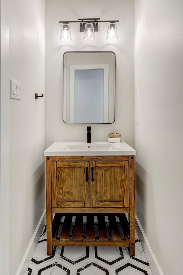 bathroom with baseboards and vanity