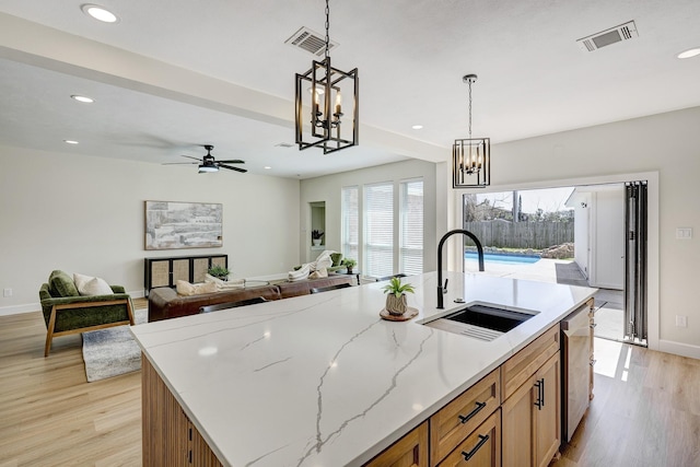 kitchen featuring recessed lighting, visible vents, stainless steel dishwasher, light wood-style floors, and a sink