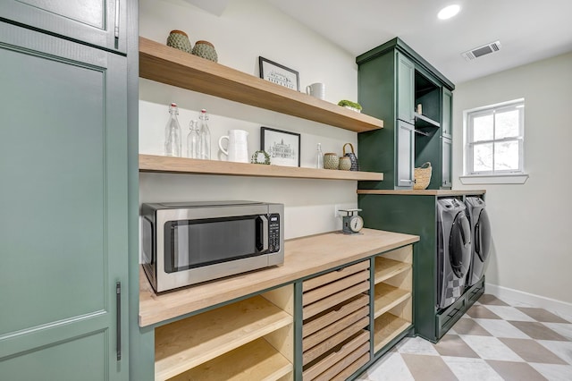 laundry area featuring washing machine and dryer, recessed lighting, laundry area, baseboards, and light floors