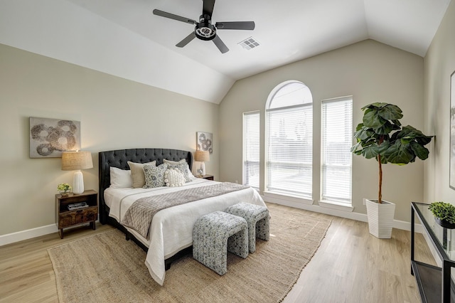 bedroom with visible vents, baseboards, a ceiling fan, lofted ceiling, and light wood-style flooring