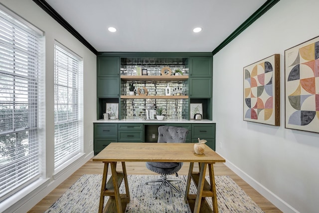 home office with recessed lighting, a bar, baseboards, light wood finished floors, and crown molding