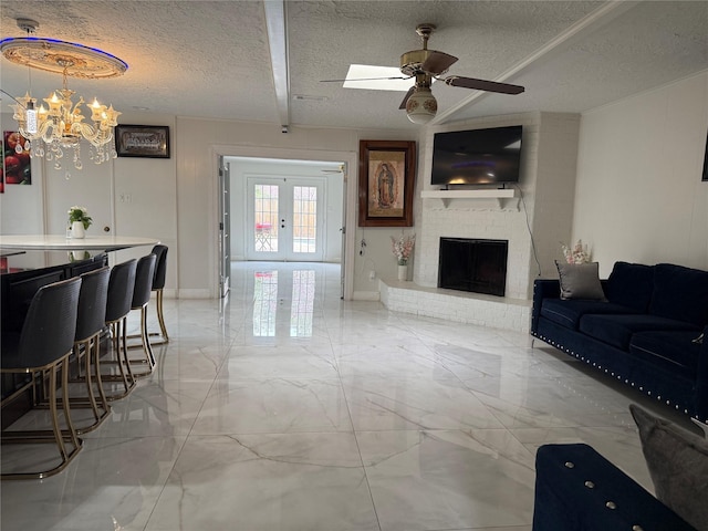 living room with a textured ceiling, baseboards, marble finish floor, french doors, and a brick fireplace