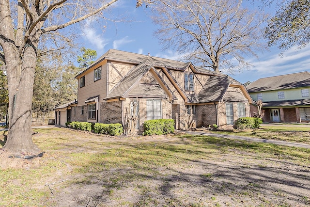 tudor-style house featuring brick siding