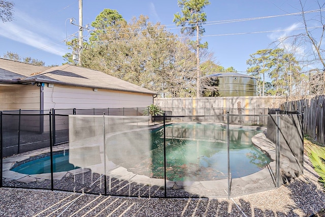 view of pool featuring a fenced backyard and a hot tub