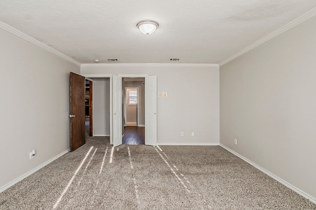 unfurnished bedroom featuring carpet floors, visible vents, ornamental molding, and a textured ceiling