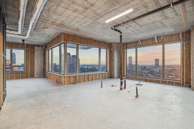 misc room featuring plenty of natural light, a view of city, and concrete flooring