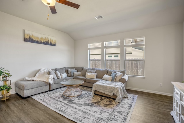 living area featuring dark wood-style floors, visible vents, baseboards, and lofted ceiling