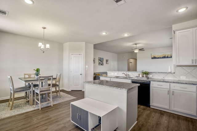 kitchen featuring dark wood finished floors, decorative backsplash, white cabinets, and black dishwasher