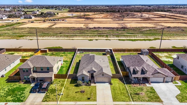 bird's eye view with a residential view and a water view