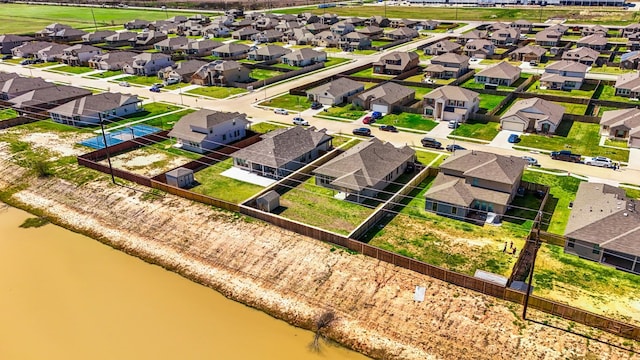 drone / aerial view with a residential view and a water view