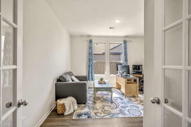 home office featuring visible vents, baseboards, and wood finished floors