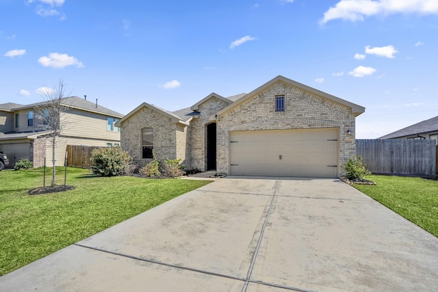 french provincial home featuring driveway, fence, a front yard, a garage, and brick siding