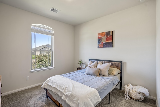 carpeted bedroom featuring visible vents and baseboards