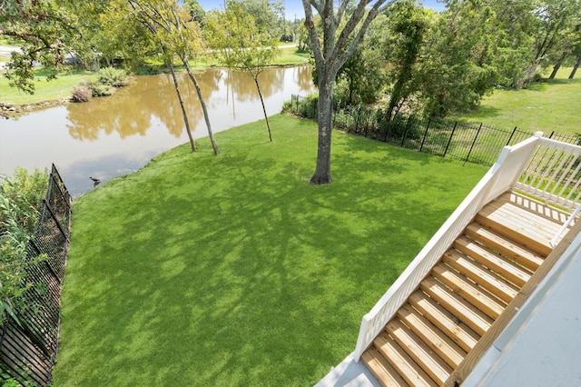 view of yard featuring a water view and fence