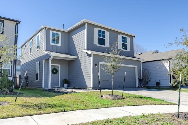 traditional-style home featuring a garage, a front lawn, driveway, and board and batten siding