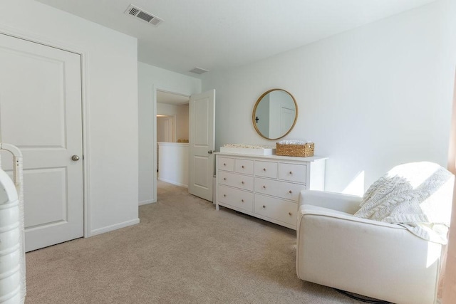 living area featuring light carpet, baseboards, and visible vents