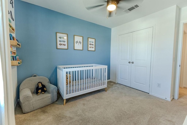 bedroom featuring baseboards, carpet, visible vents, and a closet