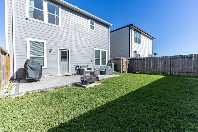 back of house with a fenced backyard, a lawn, a patio, and an outdoor hangout area