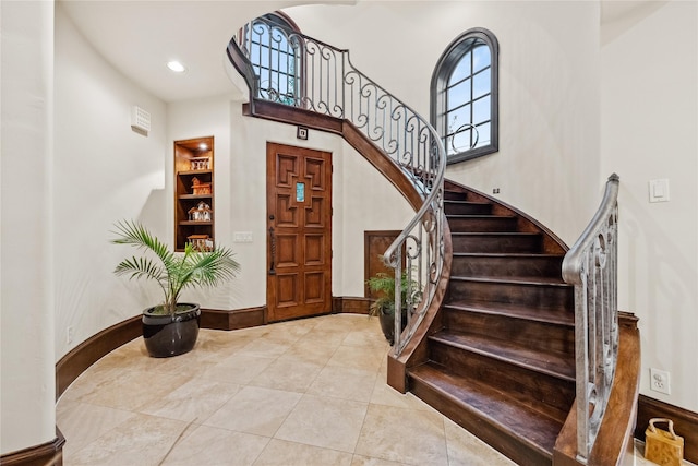 tiled entrance foyer featuring stairway and recessed lighting