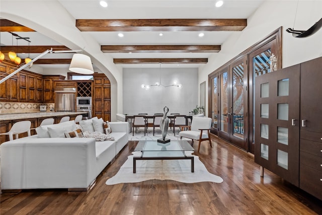 living area featuring hardwood / wood-style floors, beam ceiling, recessed lighting, and arched walkways