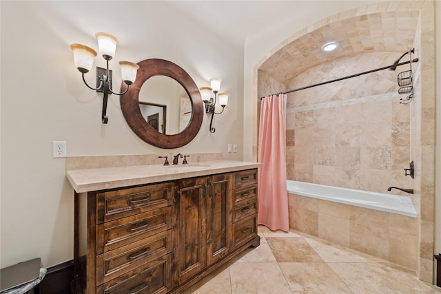 full bathroom featuring tiled shower / bath combo, an inviting chandelier, vanity, and tile patterned floors