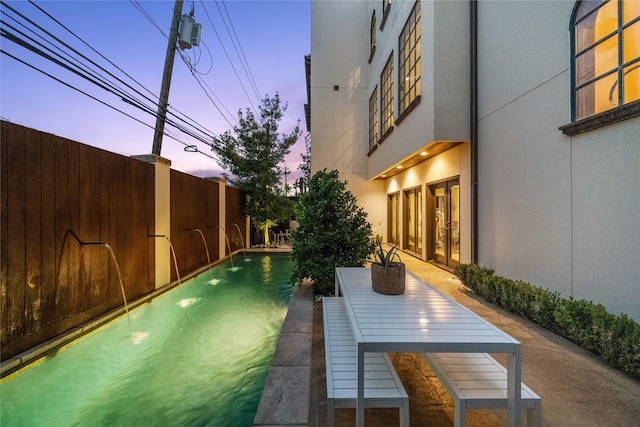 exterior space with a fenced backyard and french doors