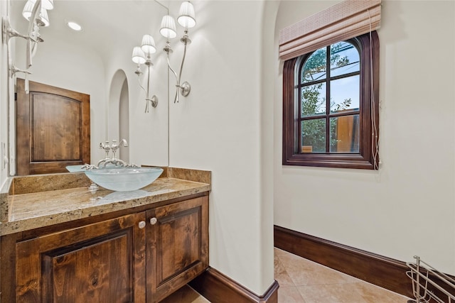 bathroom featuring tile patterned floors, baseboards, and vanity