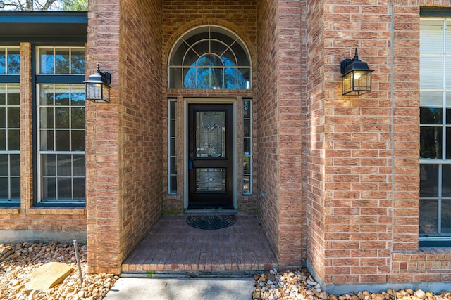 property entrance with brick siding