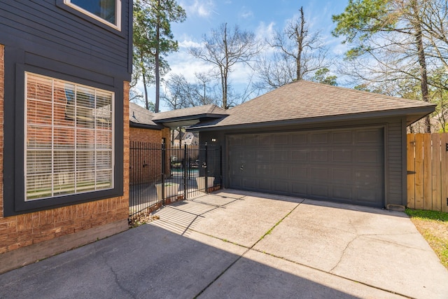 garage featuring a gate and fence