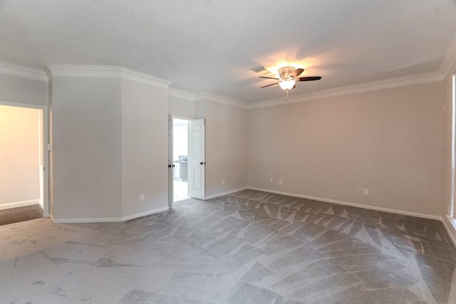 spare room featuring ornamental molding, carpet flooring, and ceiling fan