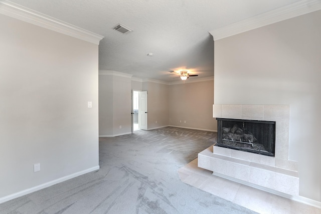 unfurnished living room featuring visible vents, carpet, baseboards, ornamental molding, and a ceiling fan