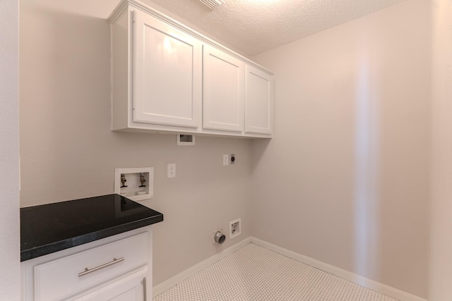 laundry room featuring baseboards, washer hookup, cabinet space, hookup for an electric dryer, and a textured ceiling