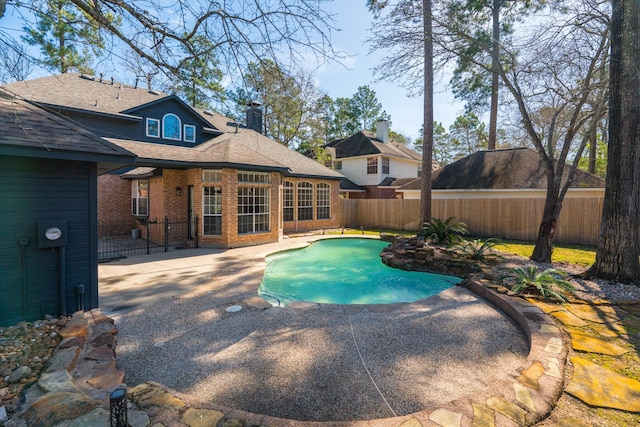 view of swimming pool with a fenced in pool, a patio, and a fenced backyard