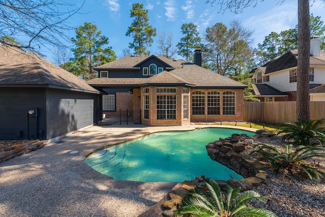 view of pool with a patio area, a fenced in pool, and fence