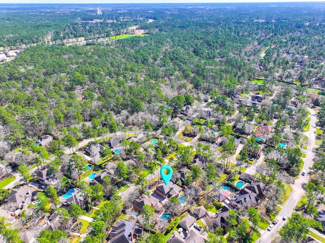 aerial view featuring a residential view and a wooded view