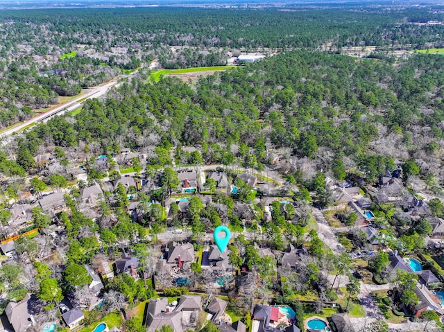 bird's eye view featuring a forest view and a residential view