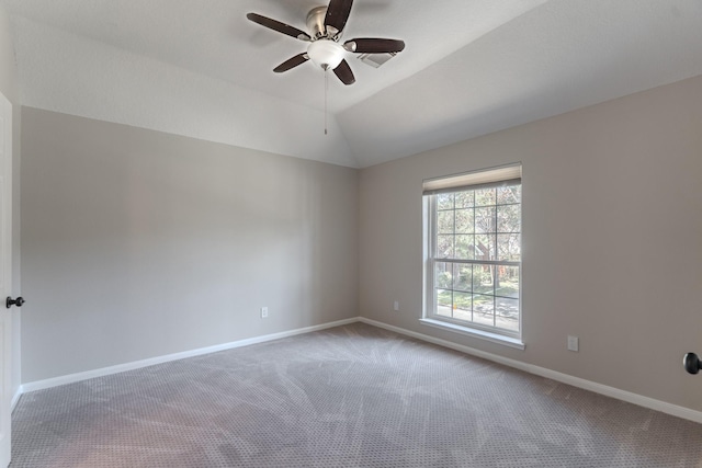 empty room featuring baseboards, carpet, lofted ceiling, and a ceiling fan