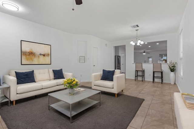 living area featuring visible vents and a ceiling fan