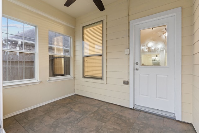 doorway to property with a patio area and a ceiling fan