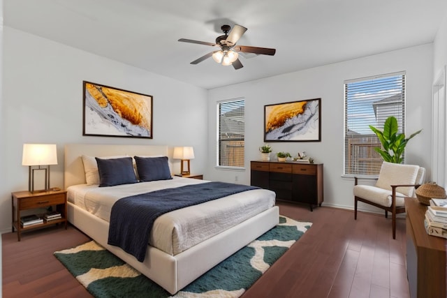 bedroom featuring ceiling fan, baseboards, and wood finished floors