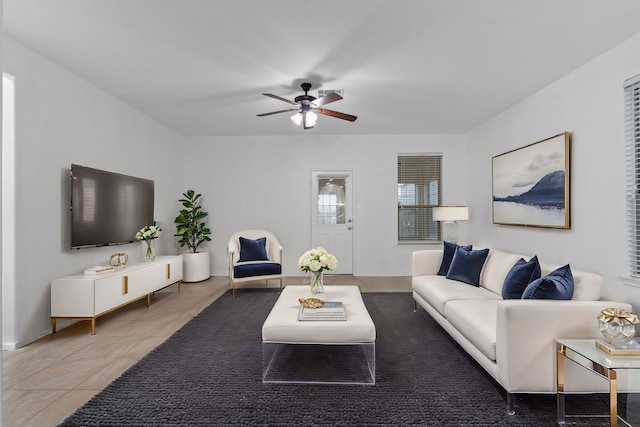 tiled living room featuring a ceiling fan