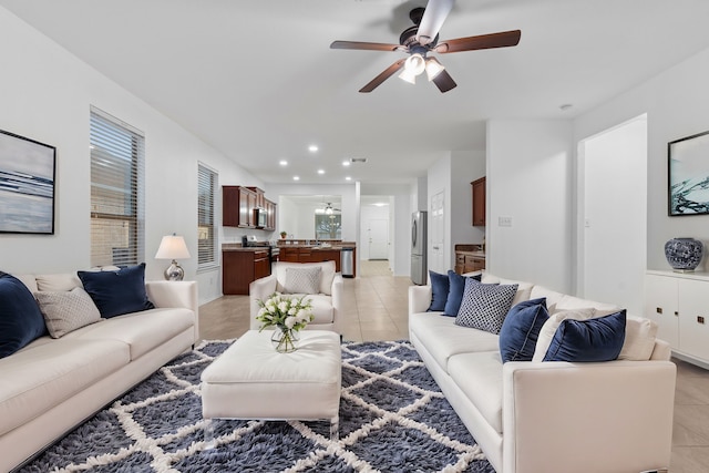 living area with light tile patterned flooring, a ceiling fan, and recessed lighting