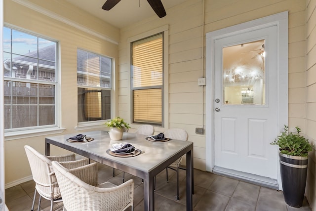 sunroom featuring a ceiling fan