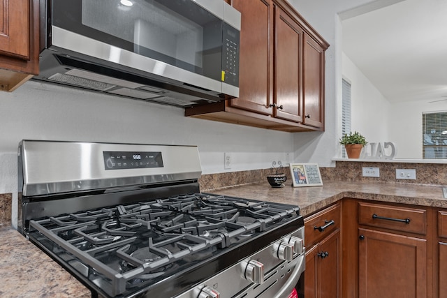 kitchen with stainless steel appliances and brown cabinetry