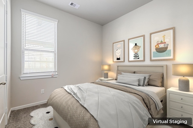 carpeted bedroom with visible vents and baseboards
