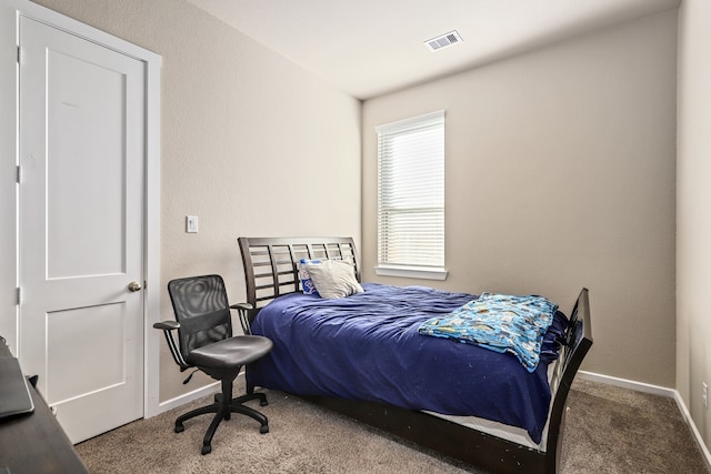 carpeted bedroom featuring baseboards and visible vents